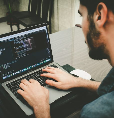 man programming using laptop